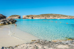 Early morning at the Blue Lagoon in Comino Malta, showing calm turquoise water and a quiet atmosphere before crowds arrive.