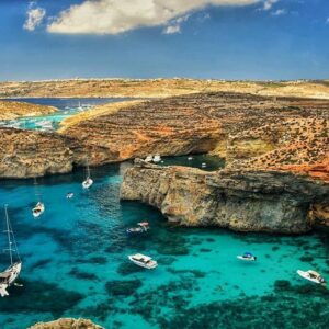 Crystal Lagoon Comino beach and sea caves with clear blue water