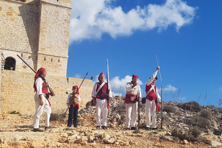 Saint Mary’s Tower on Comino, Malta, overlooking the island’s rugged coastline and clear Mediterranean Sea.