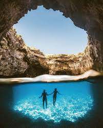 Snorkelling at Coral Lagoon in Malta during a private boat tour, enjoying clear turquoise water, rocky formations, and a peaceful swimming experience away from crowds