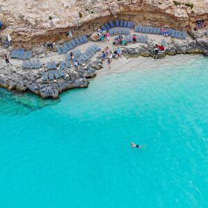 Blue Lagoon in Comino with crystal blue water and no people, photographed early morning before boats and crowds arrive.
