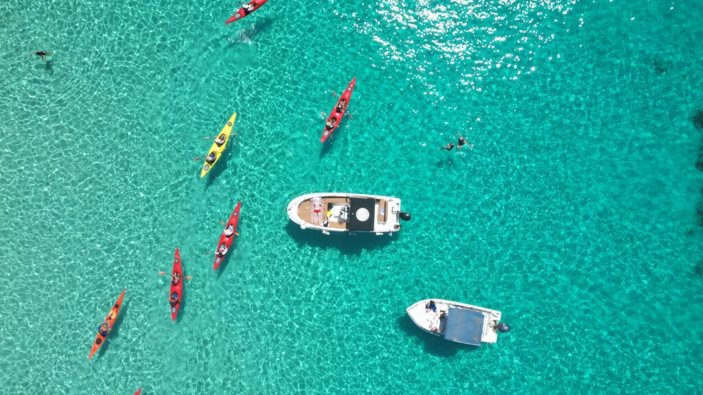 Boat at anchor and Kayaks outdoor explorers malta