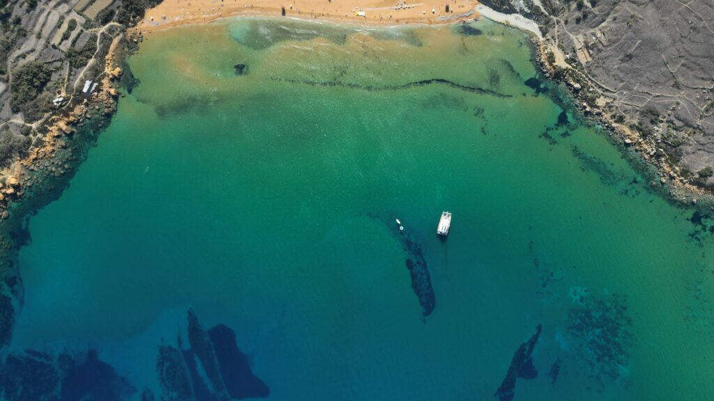 Early morning at the Blue Lagoon in Comino Malta, showing calm turquoise water and a quiet atmosphere before crowds arrive.