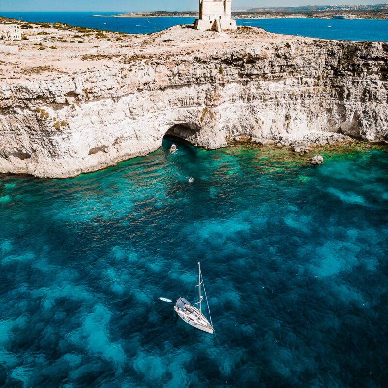 Boat tour at the Crystal Lagoon in Malta with deep blue water and limestone cliffs, enjoyed during a calm and scenic private boat experience.