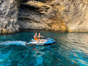Couple exploring Crystal Lagoon by Sea-Doo jet ski in Comino turquoise waters