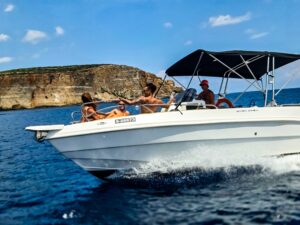 Fast private boat charter in Malta cruising on clear blue water, offering a smooth and exciting way to explore the coastline.