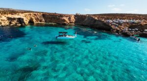 Luxury private boat at the Blue Lagoon in Malta, surrounded by crystal blue water and calm conditions during a relaxed boat charter experience.