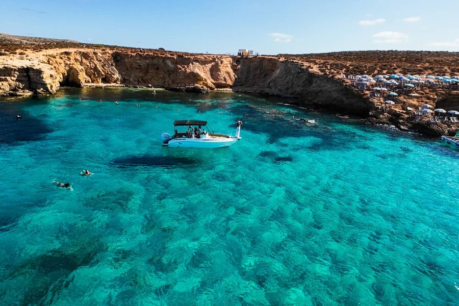 Luxury private boat at the Blue Lagoon in Malta, surrounded by crystal blue water and calm conditions during a relaxed boat charter experience.