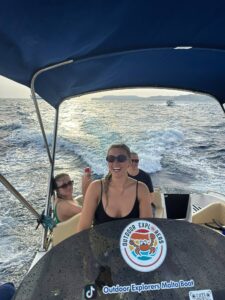 Happy client enjoying a self drive boat rental in Malta, cruising on calm blue water with no licence required.