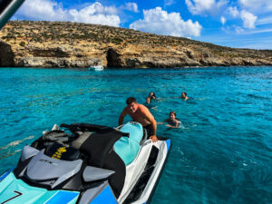 Swimmer jumping off jet ski into turquoise Blue Lagoon