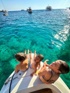 kids front of boat blue water malta private boat tour family comino crystal clear sea , family