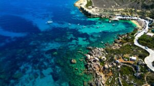 dahlet qorrot bay gozo malta fishing bay crystal clear water rocky beach traditional boats scenic coastline