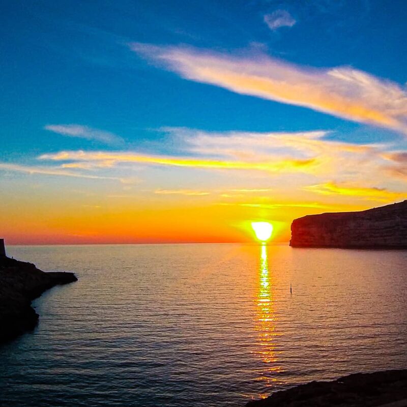 xlendi bay gozo sunset malta golden sky crystal clear water coastal village scenic view