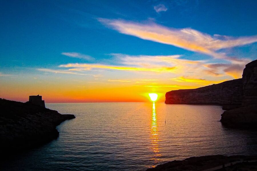 xlendi bay gozo sunset malta golden sky crystal clear water coastal village scenic view