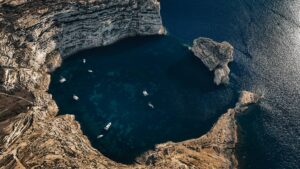 Fungus Rock at Dwejra Bay Gozo with cliffs