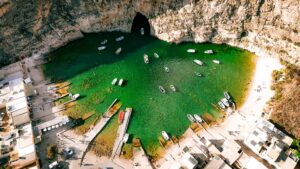 inland sea dwejra bay gozo malta lagoon tunnel crystal clear water cliffs boat ride scenic