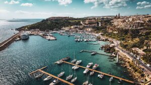 Mgarr Harbour marina Gozo with boats yachts and crystal clear water calm port view Malta island