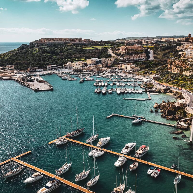 Mgarr Harbour marina Gozo with boats yachts and crystal clear water calm port view Malta island